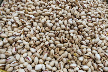 Pistachios with shell, top view. Background of pistachio nuts, whole nut kernels