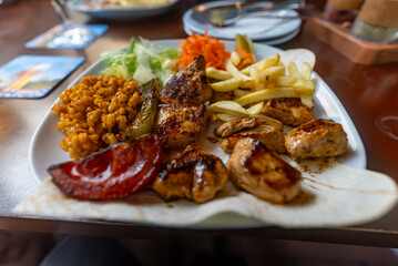 Grilled chicken breast in various variations with cherry tomatoes, green French beans, garlic, herbs