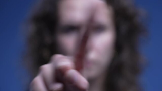 Person points finger to camera signalling "YOU" and waving finger in negation saying "NO". rejection offer