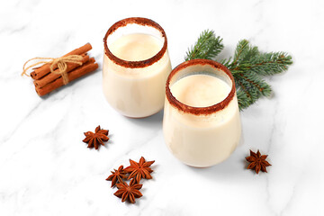Eggnog with cinnamon and nutmeg for Christmas and winter holidays. Warming egg drink during the...