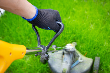 A man and lawnmower grass in the garden