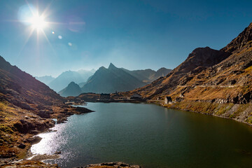 lake and mountains in Grand Saint Bernard pass at the border between Switzerland and Italy in the Alps - 678366181