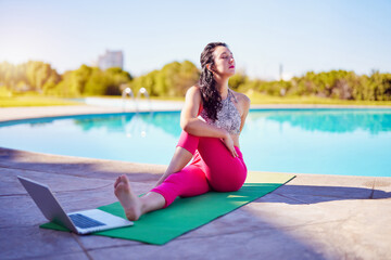 Fototapeta na wymiar Latin woman doing yoga exercises outdoors on the edge of the pool