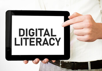Text DIGITAL LITERACY on tablet display in businessman hands on the white background. Business concept