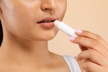 Lip Care. Indian Female Using Chapstick To Moisturize Her Beautiful Plump Lips