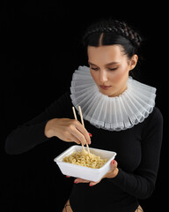 Fashioned Sexy young woman eating pasta. Sensual girl. Female mouth eat spaghetti. Young beautiful model with noodles.