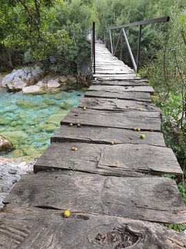 Rustic wooden bridge over small river in Valbona, Albania