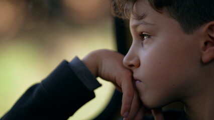 Lost in Thought of Pre-Teen Boy by Train Window, Melancholic Journey - Pensive Child's Profile Gaze