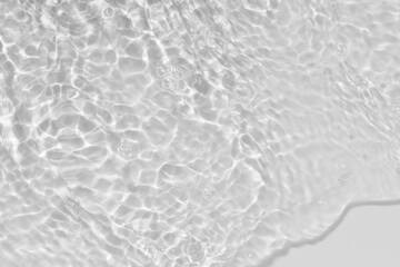Obraz premium White water with ripples on the surface. Defocus blurred transparent white colored clear calm water surface texture with splashes and bubbles. Water waves with shining pattern texture background.