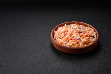 Delicious pickled salted cabbage with carrots, salt and spices