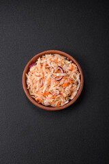 Delicious pickled salted cabbage with carrots, salt and spices