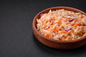 Delicious pickled salted cabbage with carrots, salt and spices