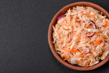 Delicious pickled salted cabbage with carrots, salt and spices