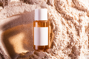 Cosmetic glass jar spf 50 on beach, beige sand background. Concept beauty advertising brochure,...
