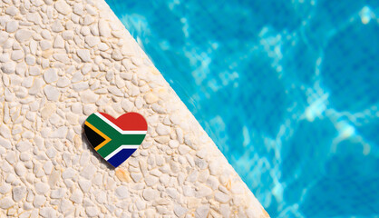 South Africa flag in the shape of a heart near the pool in the hotel. Holiday concept in hotels