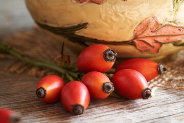 Fresh rosehip berries on a wooden table