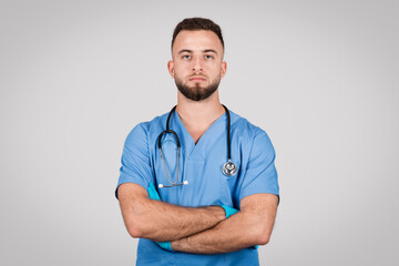 Confident male nurse with arms crossed