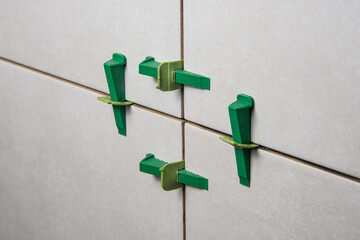 Tile leveling system with plastic clips and wedges, shot while the tile mortar sets