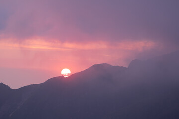 Sunrise over the mountains with dramatic orange sky