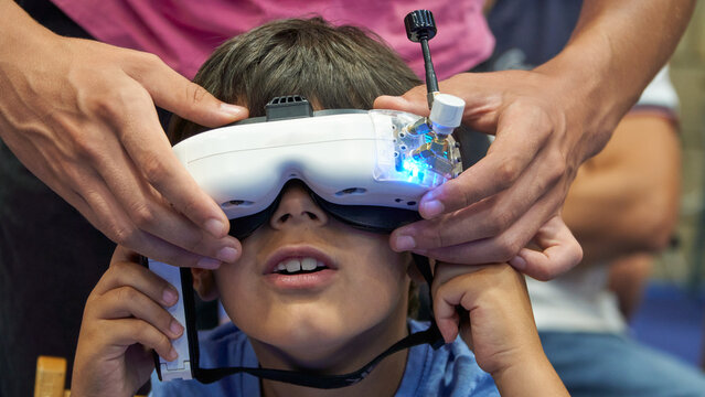 Astonished little boy with VR Drone-Control Goggles