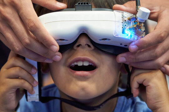 Astonished little boy with VR Drone-Control Goggles