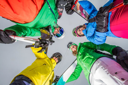 Circle of skiers ready for descent in colorful gear