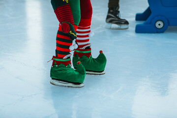 Elf-themed ice skates on festive rink surface