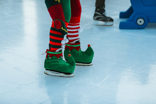 Elf-themed ice skates on festive rink surface