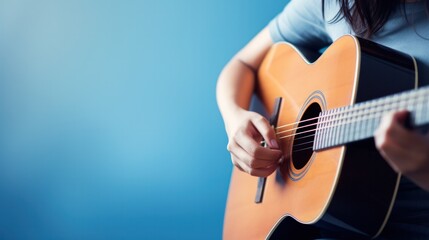 A skilled musician captivates the audience with their acoustic guitar, producing enchanting music through their skilled playing.