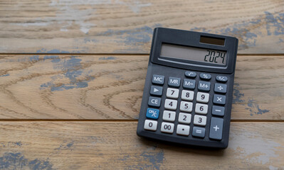 Calculator with the number 2024 on the display. Concept of finance, taxes, savings and economic...