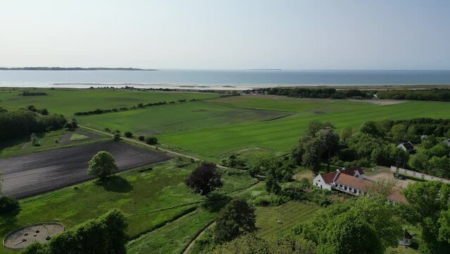 Dragsholm Castle Denmark with surrounding farms, nature and sea on a sunny day