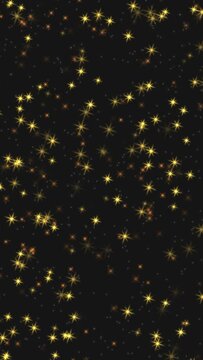 Abstract festive motion background with animated shiny golden star shape sparkle glitters confetti glowing on black backdrop. Decorative vertical video animation for Christmas or New Year holiday.