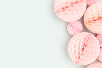 Pink tissue paper balls on a blue background. Festive concept.