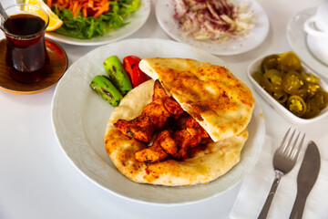 Traditional Turkish grilled chicken skewers Shish taouk with bread, fresh and pickled vegetables