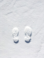 two human footprints on the snow