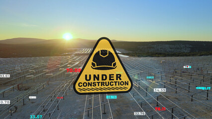 Under construction sign and infographics in front of a solar field project site