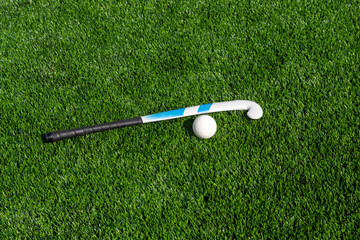 Field hockey stick and ball on green grass. Team sport concept. Horizontal sport theme poster,...