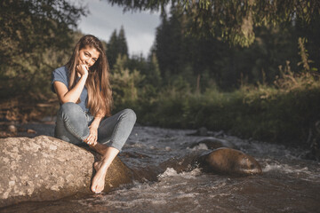 Lady on a rock in the river