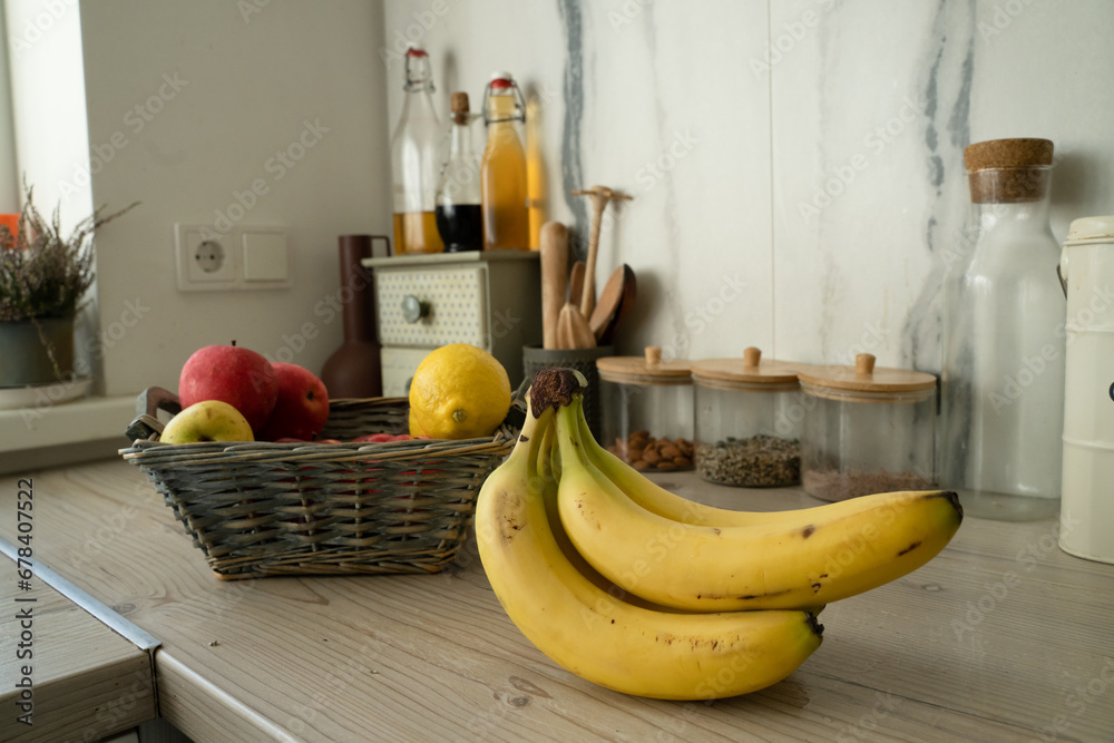 Poster Basket with fresh fruits on table in kitchen