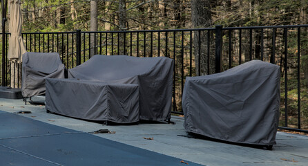 outdoor furniture covered for the season (end of year, winter) along with pool with cover (safety)...