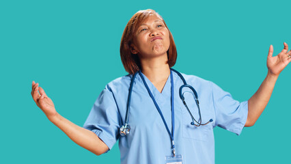 Close up shot of conflicted BIPOC nurse doing perplexed gesturing while at work. Baffled perplexed...