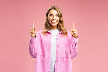 Portrait of positive young woman wearing casual outfit showing fingers, hands up, copy space...