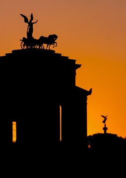 Silhouette shot of the statue of the Goddess of Victory at the Quadrigas Terrace in Rome, Italy