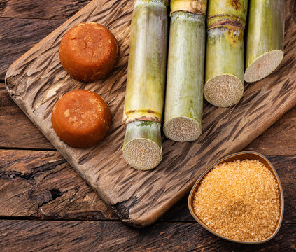 Panela and brown sugar with sugar cane stalks - Saccharum officinarum