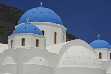 White church with blue domes in Santorini
