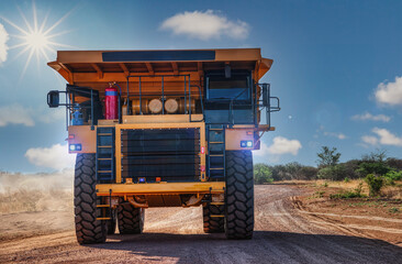 huge mining truck on a dirt road in the outback, sunny day afternoon - obrazy, fototapety, plakaty