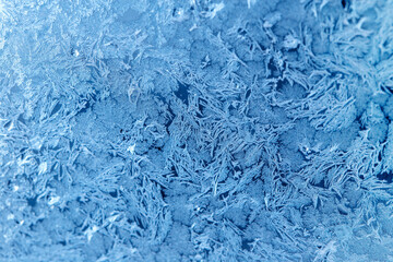 Fototapeta na wymiar Beautiful natural frosty pattern on winter window.