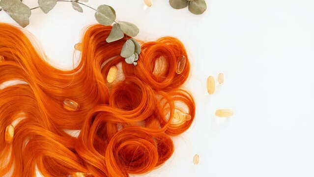 Redheads shiny wavy hair on white background. Shiny woman hair strand, curl. Hair care and beauty salon. Natural cosmetic products. Hair color palette. . High quality 4k footage