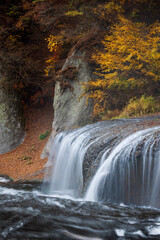 Beautiful cascade waterfall surrounded by autumn colors