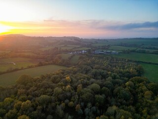 Aerial drone shot of a calm sunrise over the Halesowen fields, England